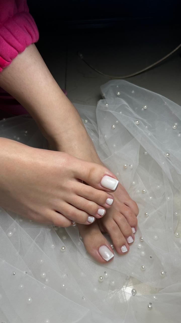 White French pedicure on pearl bridal tulle