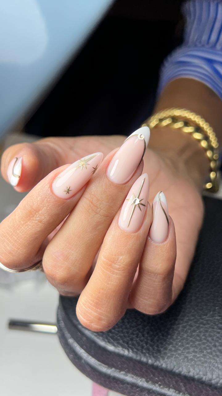 Nude almond nails with silver celestial star art