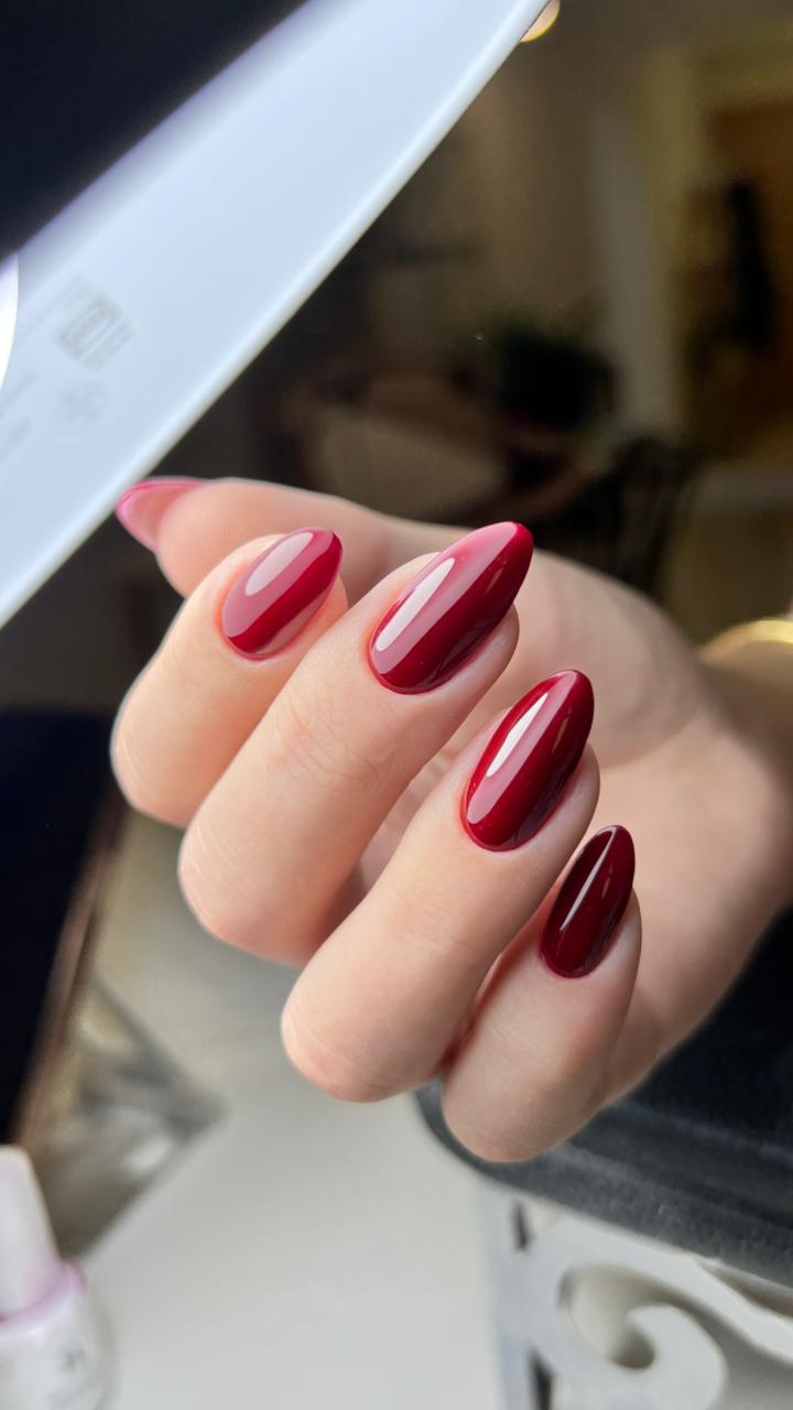 Deep cherry-red glossy almond nails