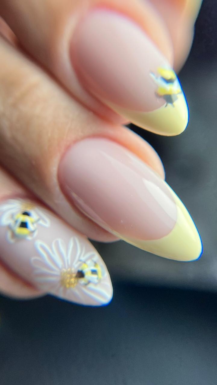 Yellow French almond nails with daisy and bee art