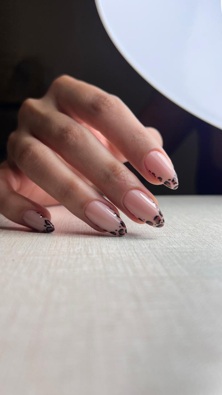Nude almond nails with hand-painted leopard tips