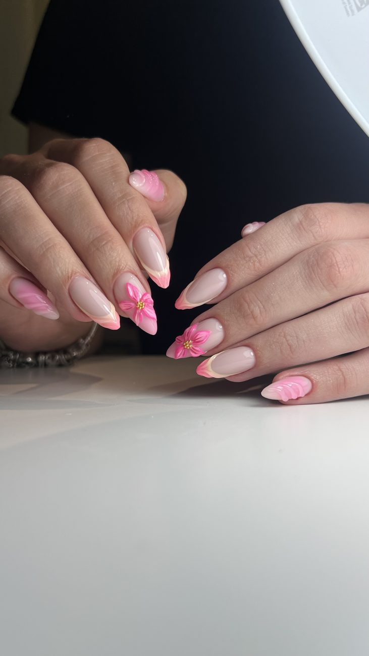 Pink French almond nails with sculpted 3D flowers