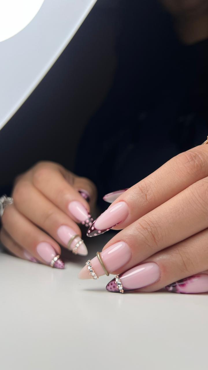 Plum French tips with dots, gems and gold accents