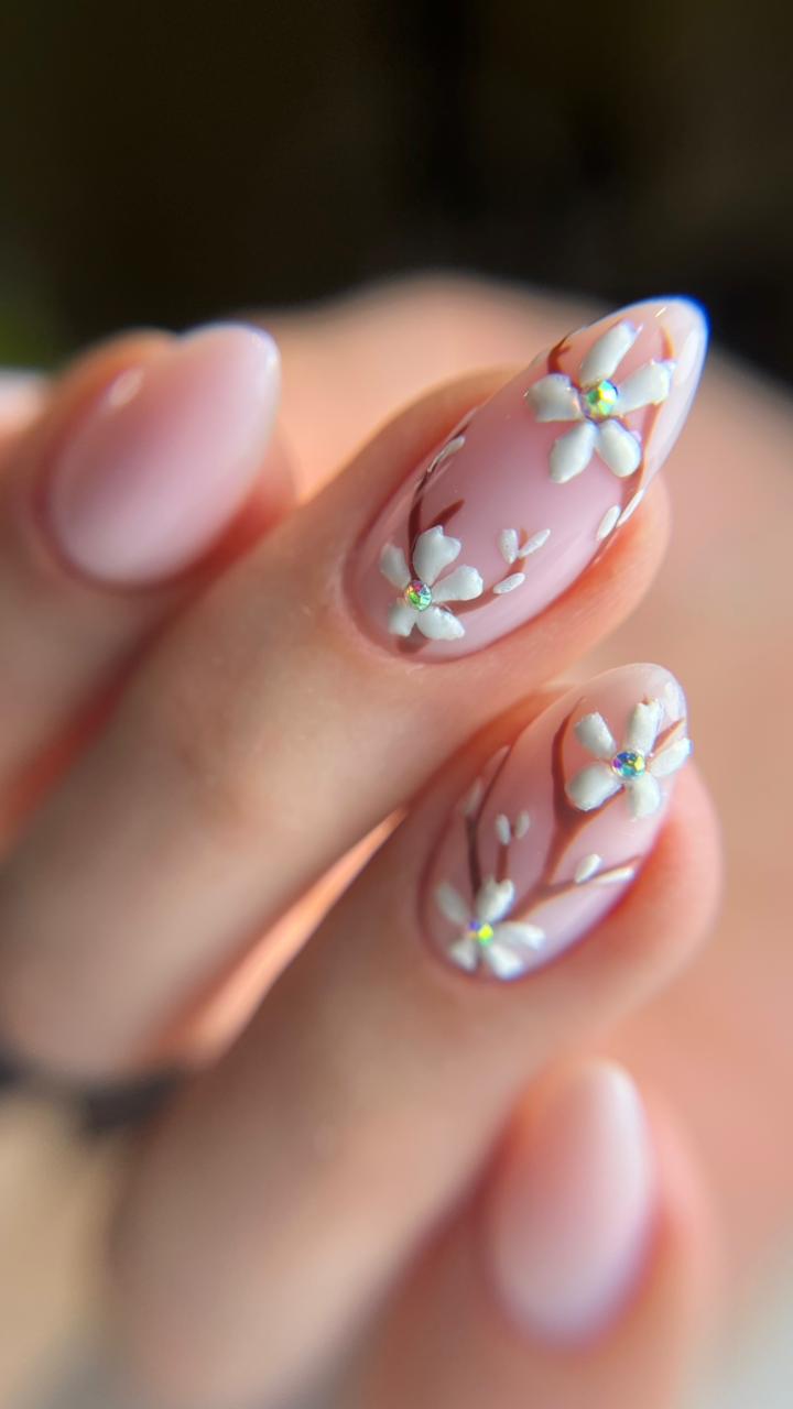 Nude almond nails with sculpted white 3D flowers
